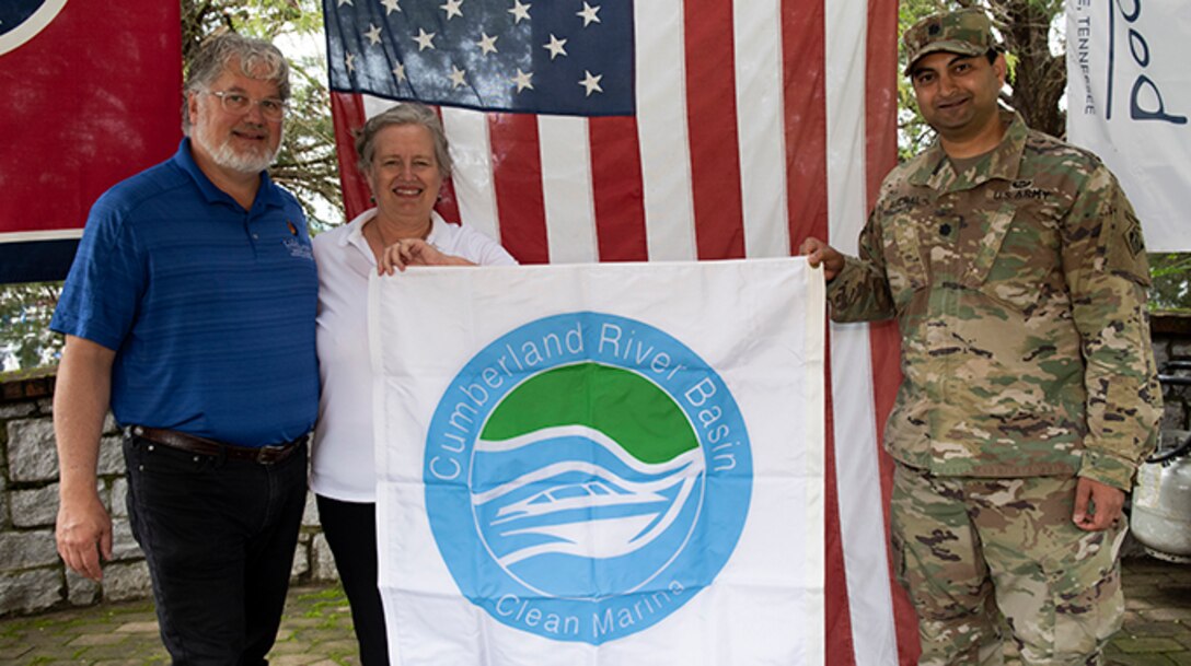 Lt. Col. Sonny B. Avichal, U.S. Army Corps of Engineers Nashville District commander, presents the “Clean Marina” flag to John and Natasha Deane, owners of Wildwood Resort and Marina, during a dedication May 21, 2020 at the resort located at Cordell Hull Lake in Granville, Tennessee.  The event recognized the marina’s voluntary efforts to reduce water pollution and erosion in the Cumberland River watershed, and for promoting environmentally responsible marina and boating practices. (USACE photo by Lee Roberts)