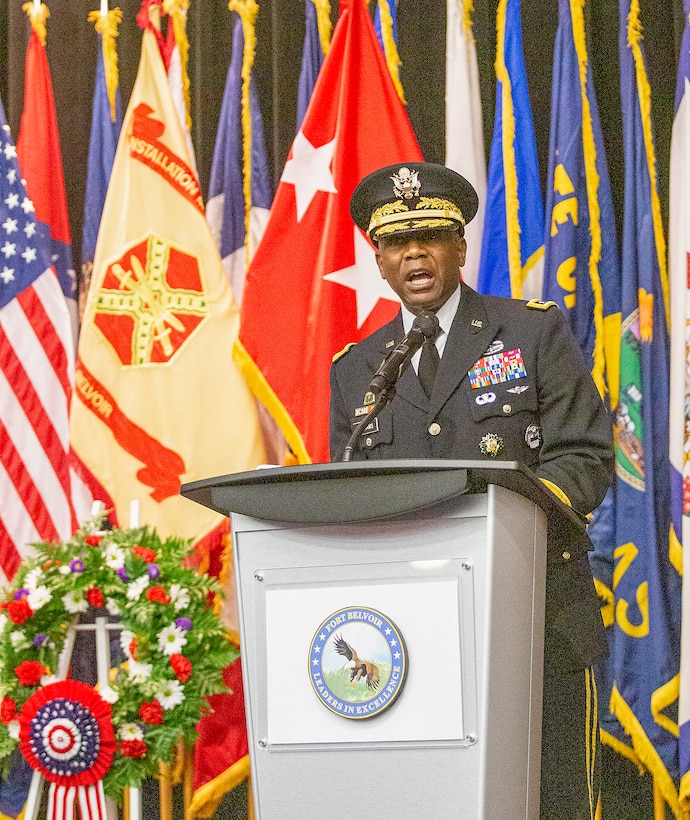 Army Lt. Gen. Darrell K. Williams delivered a keynote address behind a lectern with flags in the background.
