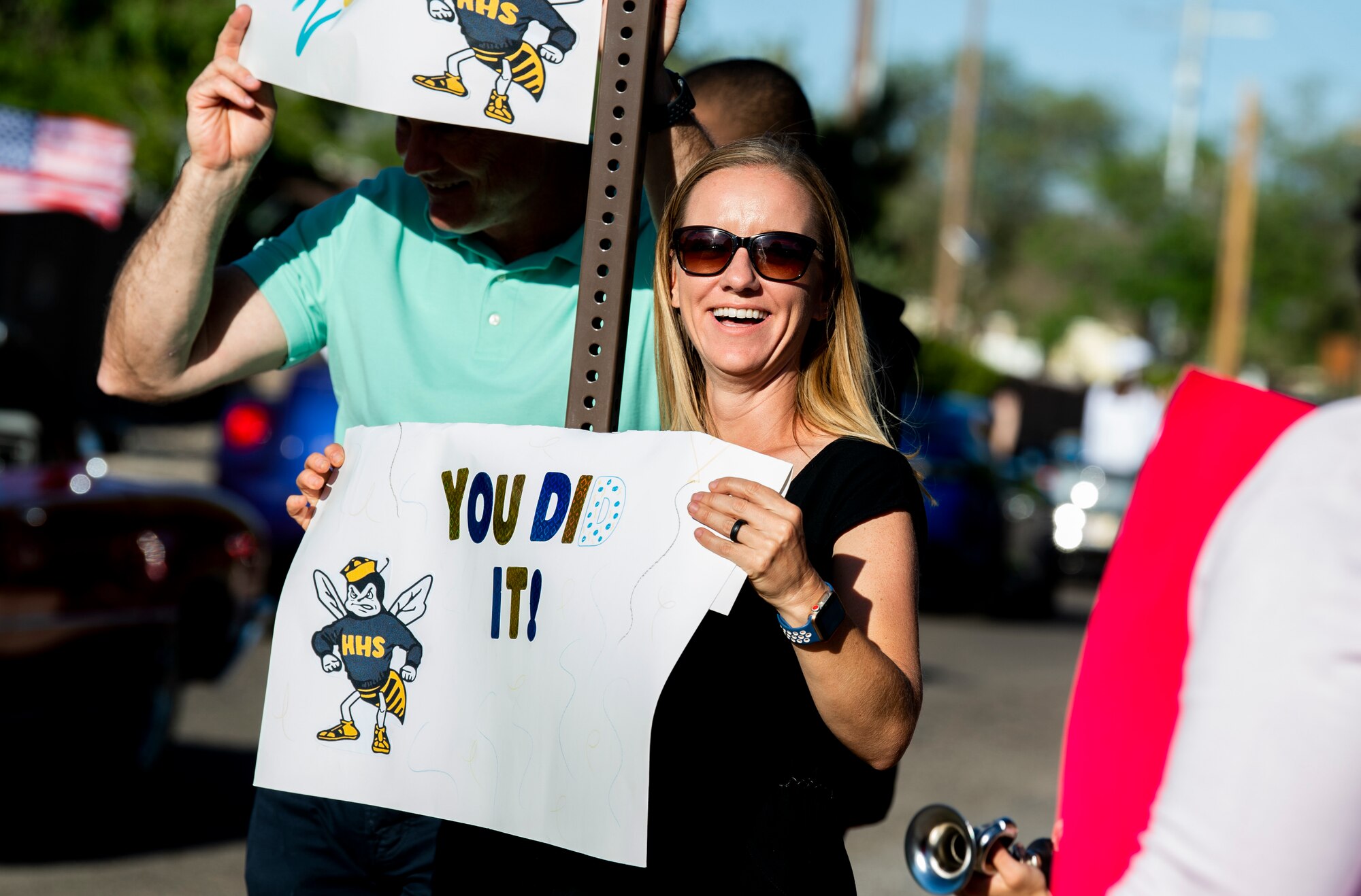 A woman holds a sign.