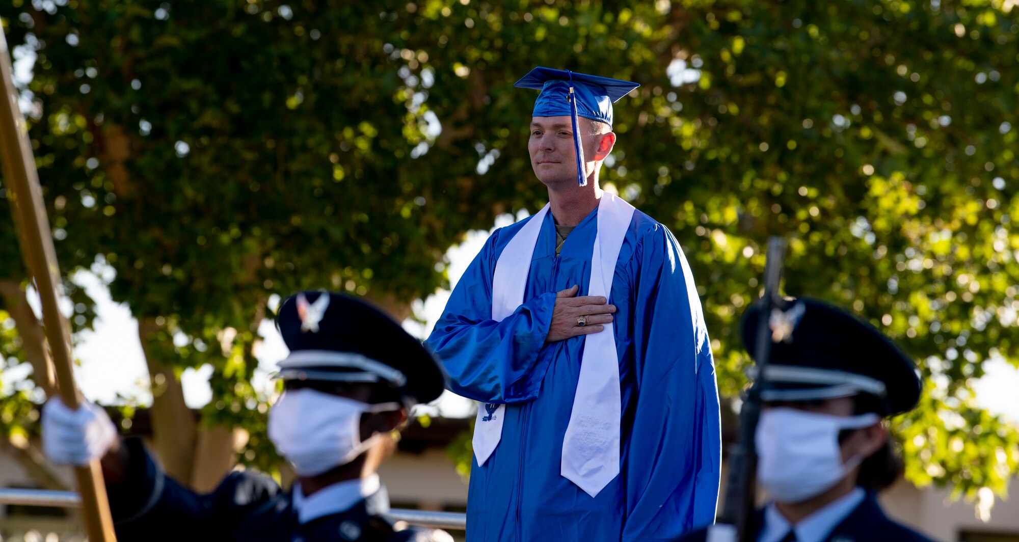 U.S. Air Force Col. David S. Miller, 377th Air Base Wing commander, stands for the playing of the National Anthem.