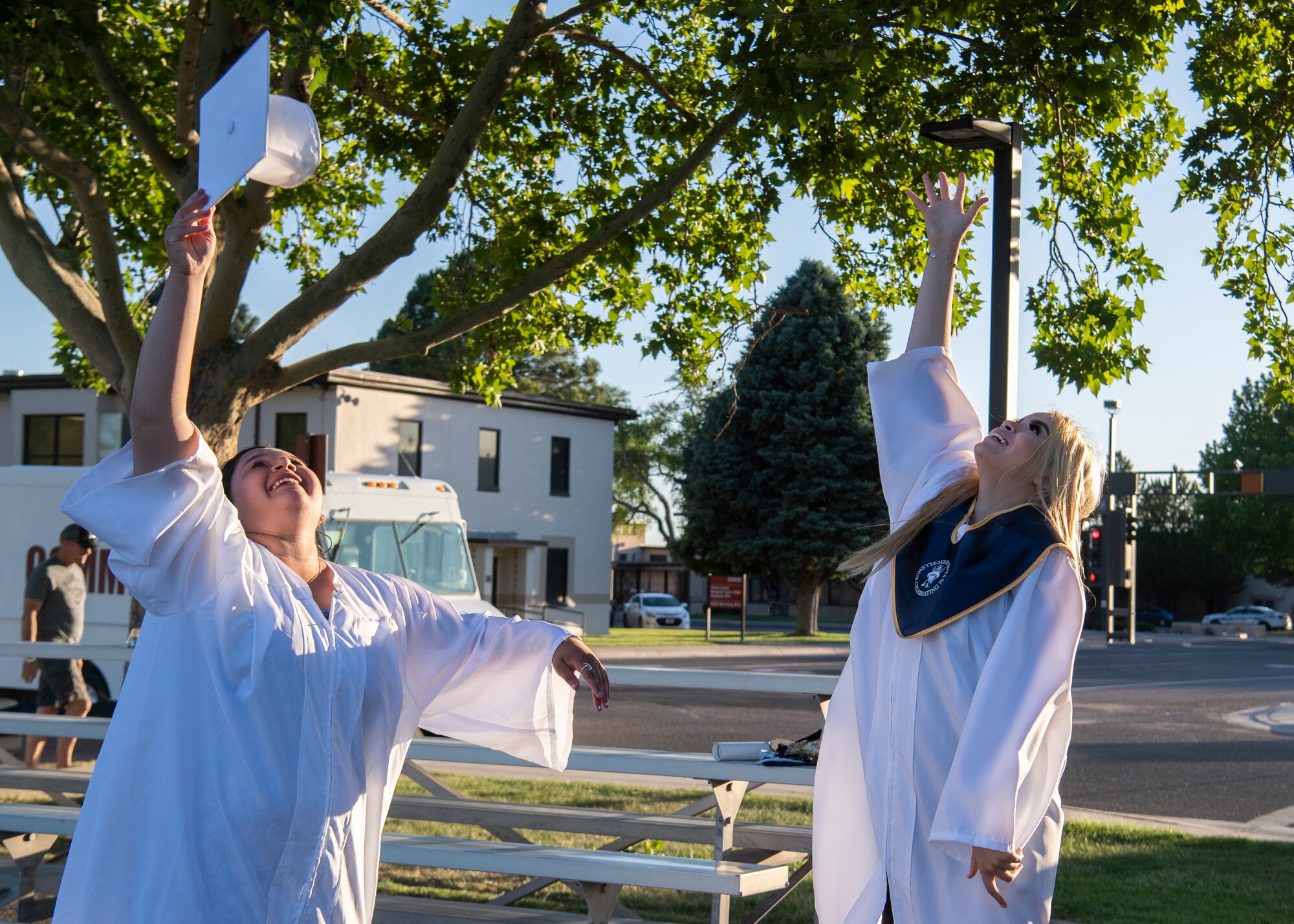 Graduates toss their caps in the air.