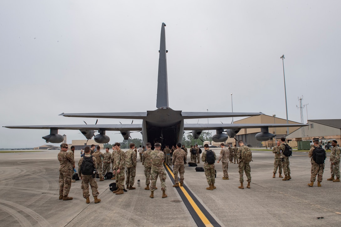 A photo of Airmen waiting to board an aircraft