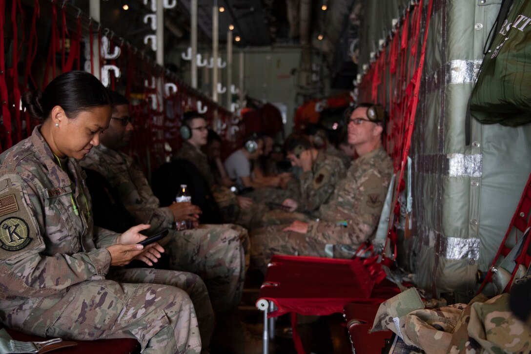 A photo of Airmen sitting on a plane