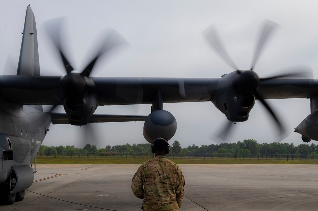 A photo and Airmen performing preflight checks