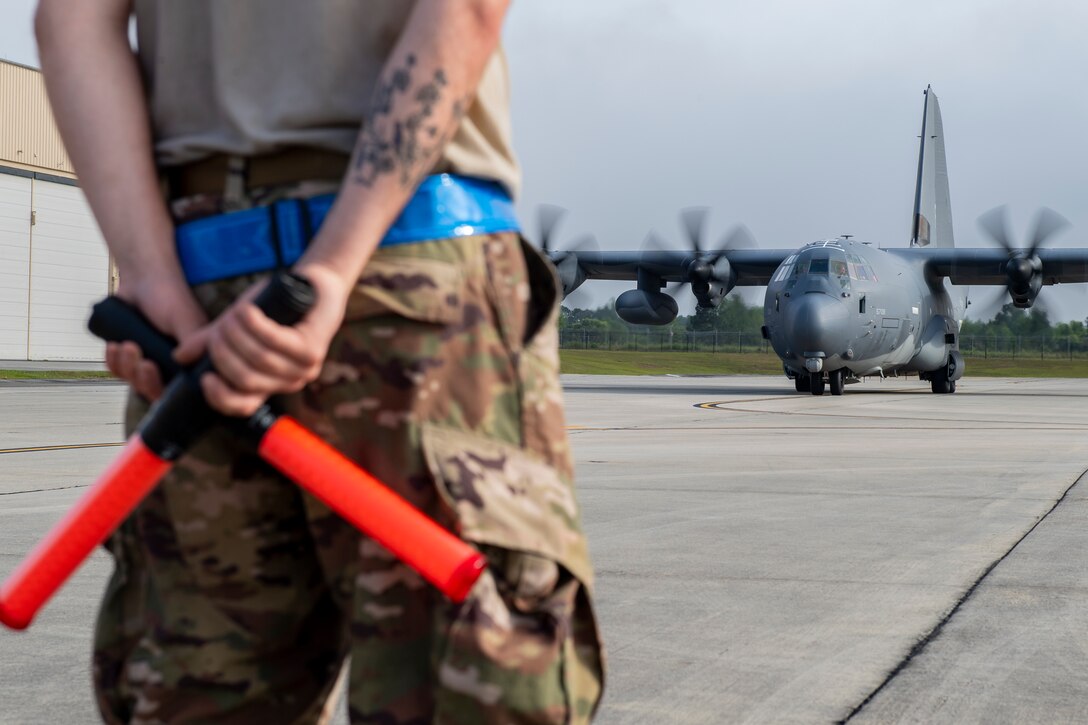 A photo of and Airmen standing in front of an aircraft