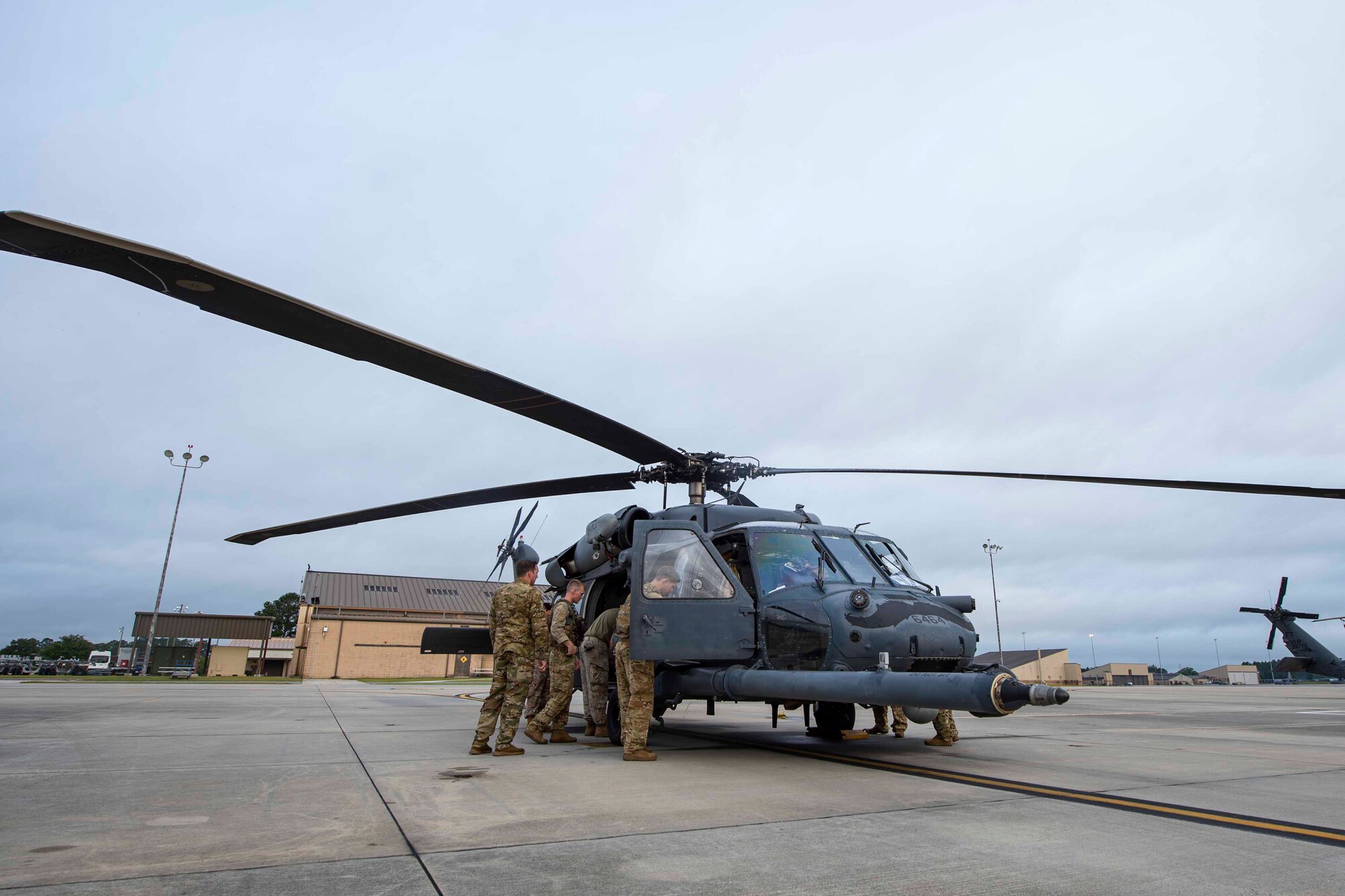 Photo of Airmen assigned to the 41st Rescue Squadron preparing for flight.