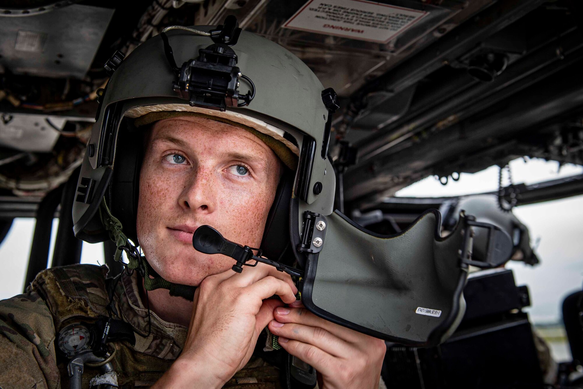 Photo of an Airman securing a helmet.