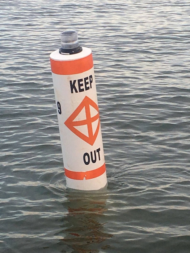 A lighted buoy is shown to warn boaters of the navigation hazards located within the construction zone off of Poplar Island.