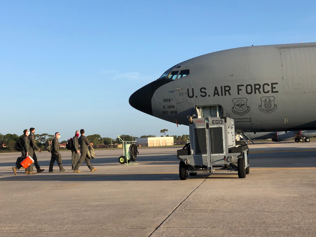 Aircrew with the 63rd Air Refueling Squadron walk toward a KC-135 Stratotanker aircraft, May 15, 2020 at MacDill Air Force Base, Fla.
