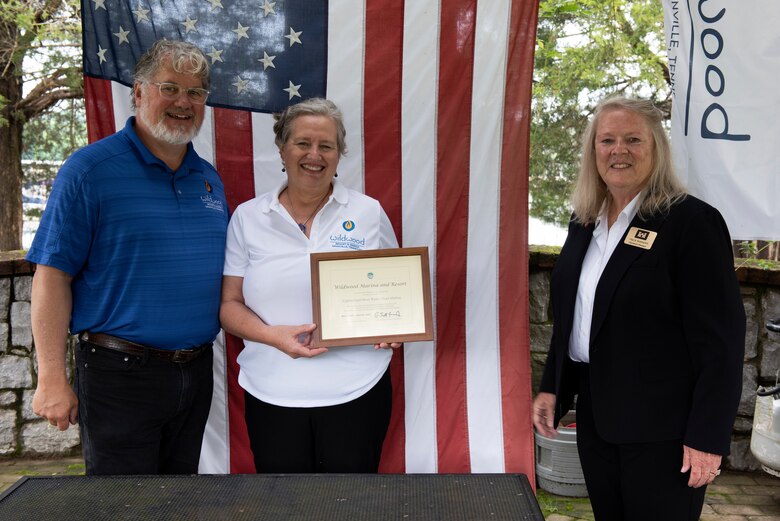 Olga Beddingfield (Right), U.S. Army Corps of Engineers Nashville District’s Mid-Cumberland Area Operations manager, presents a certificate of achievement to John and Natasha Deane, owners of Wildwood Resort and Marina, during a “Clean Marina” dedication May 21, 2020 at the resort located at Cordell Hull Lake in Granville, Tennessee.  The event recognized the marina’s voluntary efforts to reduce water pollution and erosion in the Cumberland River watershed, and for promoting environmentally responsible marina and boating practices. (USACE photo by Lee Roberts)