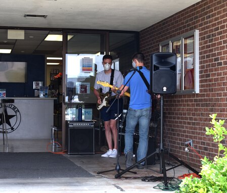 Goodfellow students warm up for their live performance during the Memorial Day BBQ in front of Crossroads on Goodfellow Air Force Base, Texas, May 23, 2020. The students played a variety of covers during the BBQ hosted by the Chaplin and First Sergeant Council. (U.S. Air Force photo by Senior Airman Seraiah Wolf)