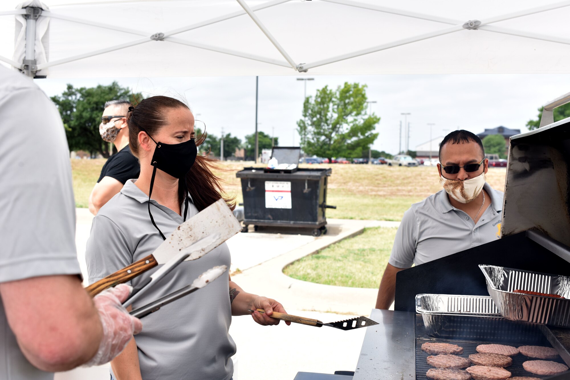 Members of the First Sergeant Council cook burgers and hotdogs outside of the Crossroads on Goodfellow Air Force Base, Texas, May 23, 2020. The first sergeants cooked hamburgers and hotdogs for students in observance of Memorial Day. (U.S. Air Force photo by Senior Airman Seraiah Wolf)