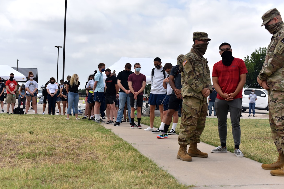 Goodfellow students observe a moment of silence during the Memorial Day BBQ at the Crossroads on Goodfellow Air Force Base, Texas, May 23, 2020. The BBQ was hosted by the Chapel and first sergeant council to let the students know they are thought about. (U.S. Air Force photo by Senior Airman Seraiah Wolf)