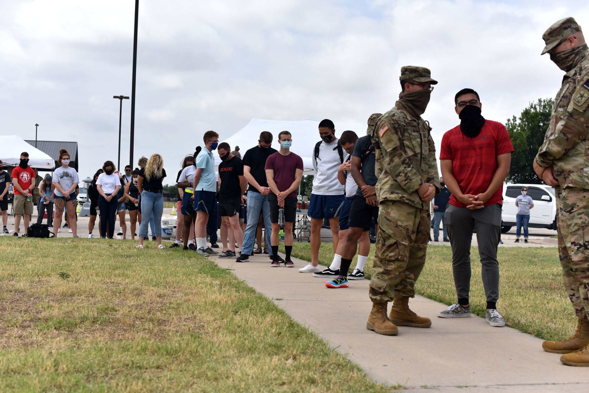 Goodfellow students observe a moment of silence during the Memorial Day BBQ at the Crossroads on Goodfellow Air Force Base, Texas, May 23, 2020. The BBQ was hosted by the Chapel and first sergeant council to let the students know they are thought about. (U.S. Air Force photo by Senior Airman Seraiah Wolf)