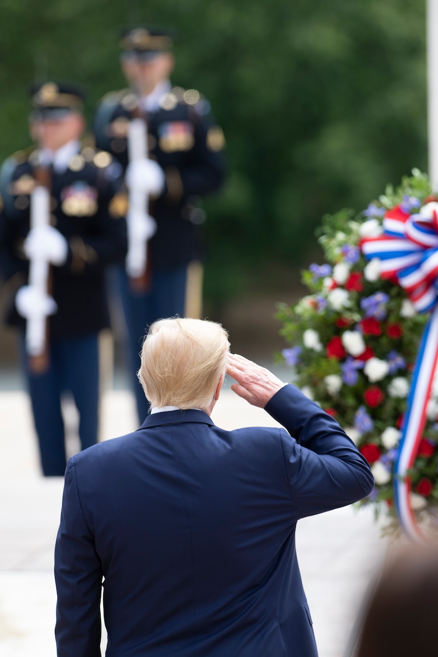 President salutes during a wreath-laying ceremony.