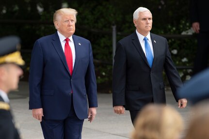 President and vice president walk side by side during a ceremony.
