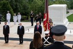 Four men stand attention at the Tomb of the Unknown Soldier.