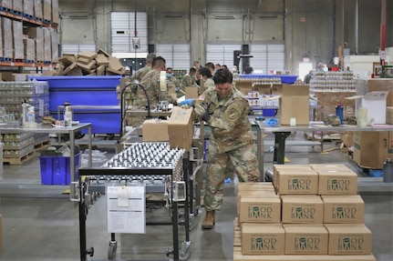 U.S. Army Soldiers with Joint Task Force 224, California Army National Guard, build emergency food kits in response to the COVID-19 pandemic at the Los Angeles Regional Food Bank in Commerce, California, April 29, 2020. The food bank put together over 250,000 emergency kits – more than 5 million pounds of food products.