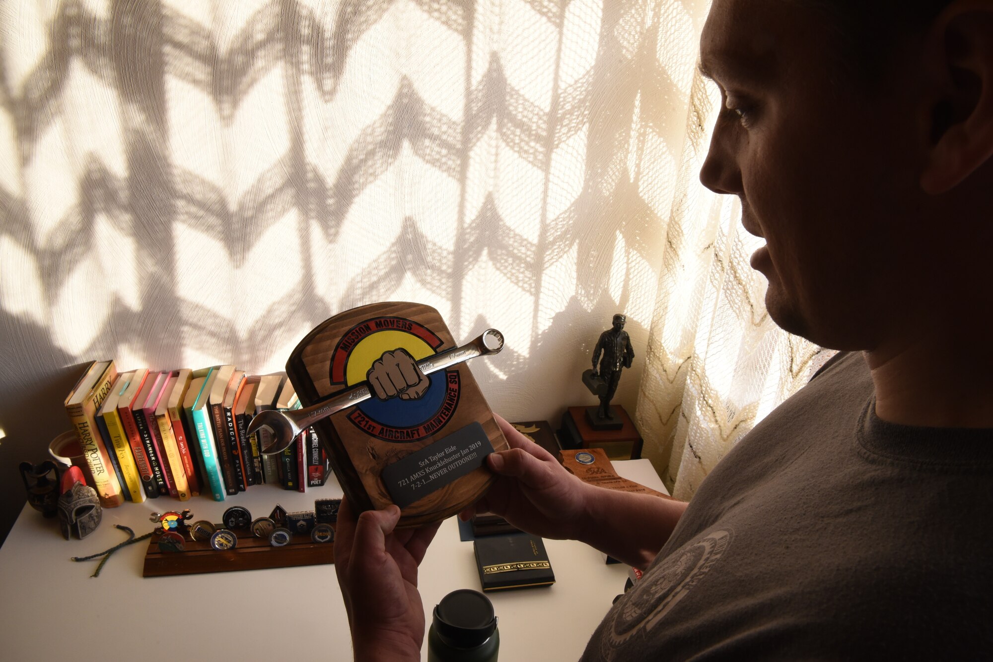 U.S. Air Force Staff Sgt. Taylor J. Eide, 721st Aircraft Maintenance Squadron quality assurance inspector, explains what it takes to receive the 721st AMXS Knucklebuster Award at his home in Hütschenhausen, Germany, May 20, 2020.