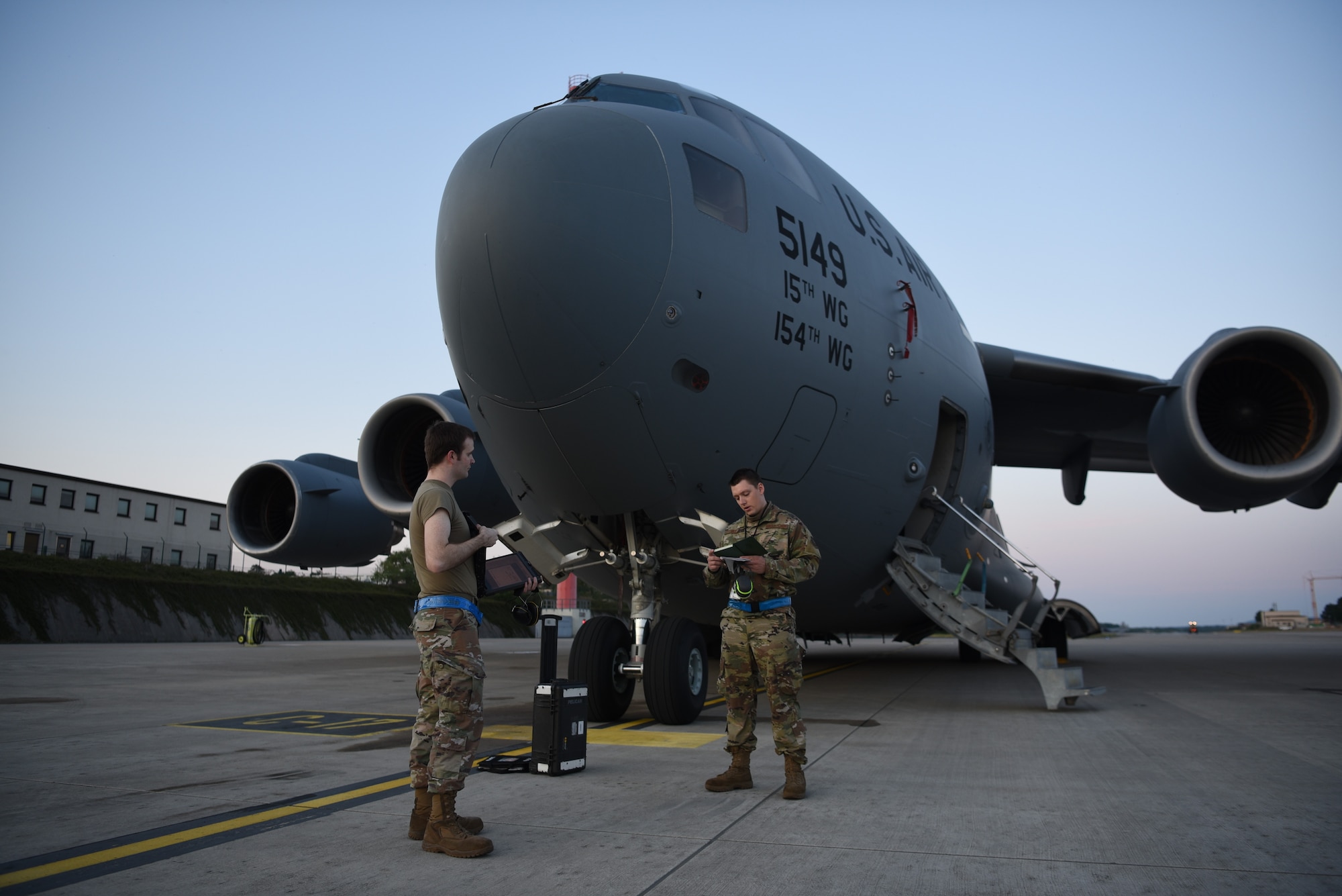 U.S. Air Force Staff Sgt. Taylor J. Eide, right, 721st Aircraft Maintenance Squadron quality assurance inspector, gives a personal evaluation brief to Staff Sgt. Theodore Ellis, 721st AMXS crew chief craftsman, at Ramstein Air Base, Germany, May 21, 2020.