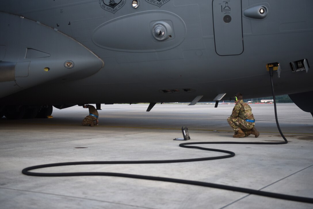 U.S. Air Force Staff Sgt. Taylor J. Eide, right, 721st Aircraft Maintenance Squadron quality assurance inspector, observes as Staff Sgt. Theodore Ellis, 721st AMXS crew chief craftsman, inspects the anti-collision light of a C-17 Globemaster III aircraft at Ramstein Air Base, Germany, May 21, 2020.