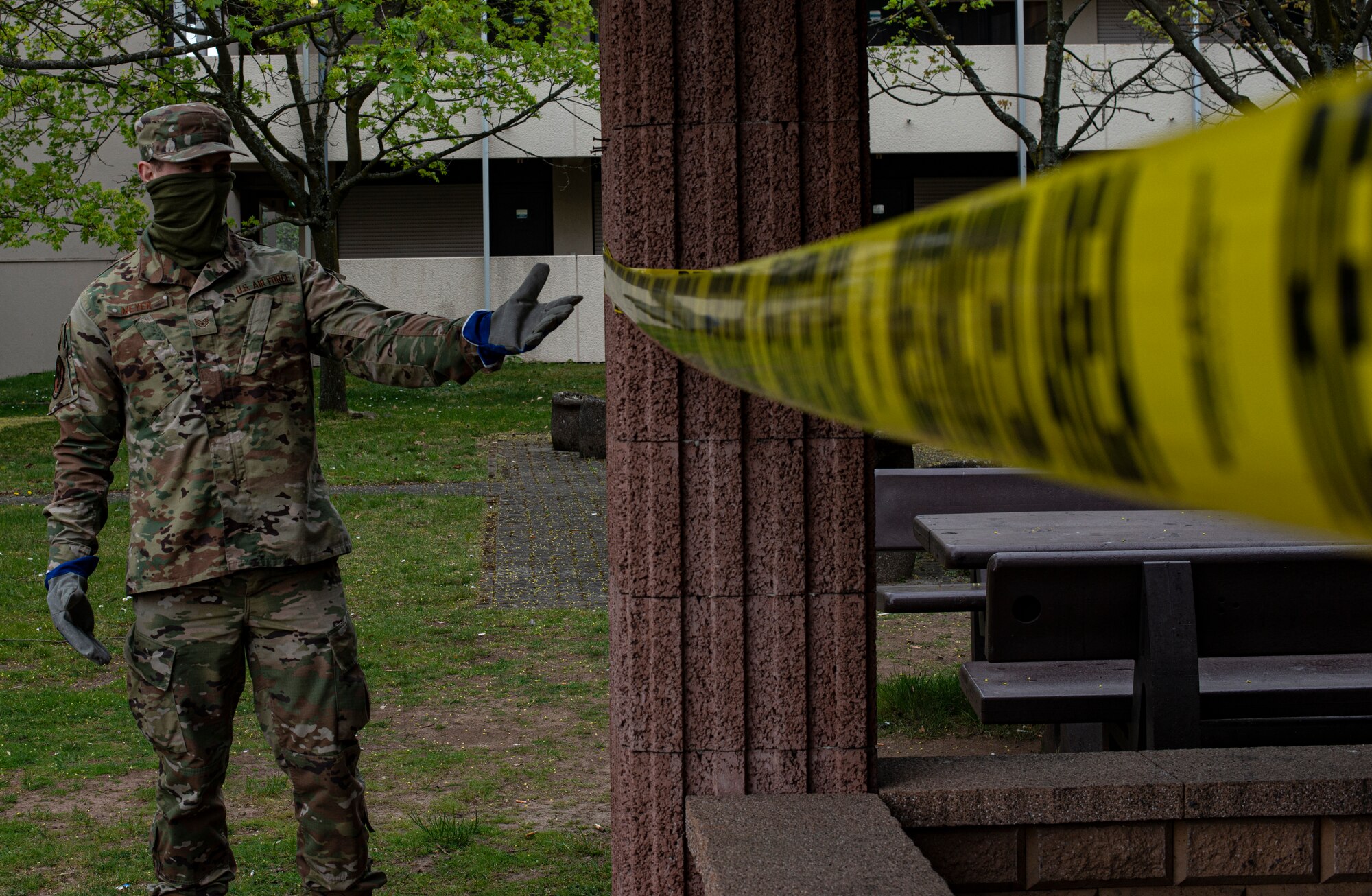 U.S. Air Force Staff Sgt. Patrick Meyer, 86th Civil Engineer Squadron airman dorm leader, gestures to a cordon around a gazebo at Ramstein Air Base, Germany, April 14, 2020.
