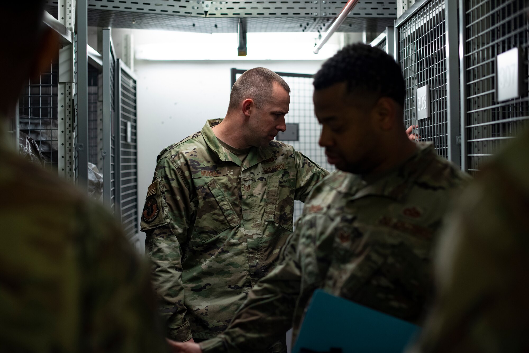 U.S. Air Force Tech. Sgt. Corey J. Musial, 86th Civil Engineer Squadron airman dorm leader and Tech. Sgt. James Green, 86th Civil Engineer Squadron unaccompanied housing non-commissioned officer in charge, inspect the storage room cages in a dorm basement at Ramstein Air Base, Germany, April 15, 2020.