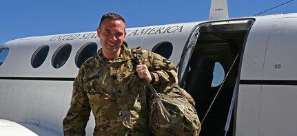 Capt. Brendan Meehan, a pilot with the 238th Medevac Company, arrives at the NHNG Army Aviation Support Facility in Concord on May 22, following a lengthy stay at Walter Reed Medical Center.