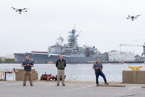 Norfolk Naval Shipyard’s (NNSY) Refueling Secretary Branch (Code 1124) Drone Pilot John Powell, Branch Head Robert Hale and Drone Pilot Jose Del Olmo demonstrate the Unmanned Aerial Systems (UAS), also known as drones, used to evaluate damage caused by a recent storm.