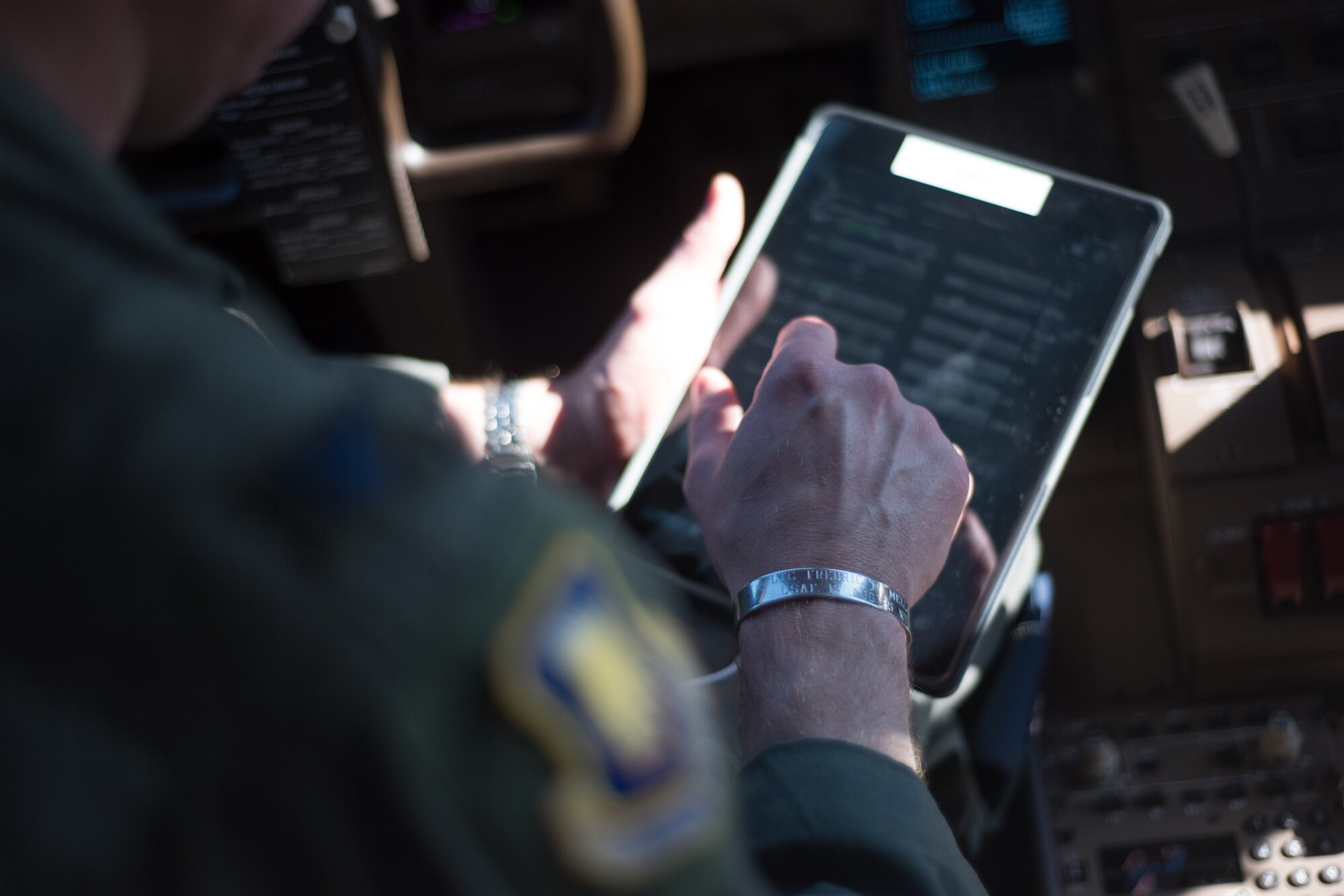 Col. Mark Baran, 22nd Air Refueling Wing vice commander, refers to a KC-46 Pegasus preflight checklist before flight May 19, 2020 at McConnell Air Force Base, Kansas. Baran wears a memorial bracelet every mission over the past 18 years, he believes that it has given him good luck from conflicts downrange and training missions stateside. (U.S. Air Force photo by Senior Airman Michaela Slanchik)