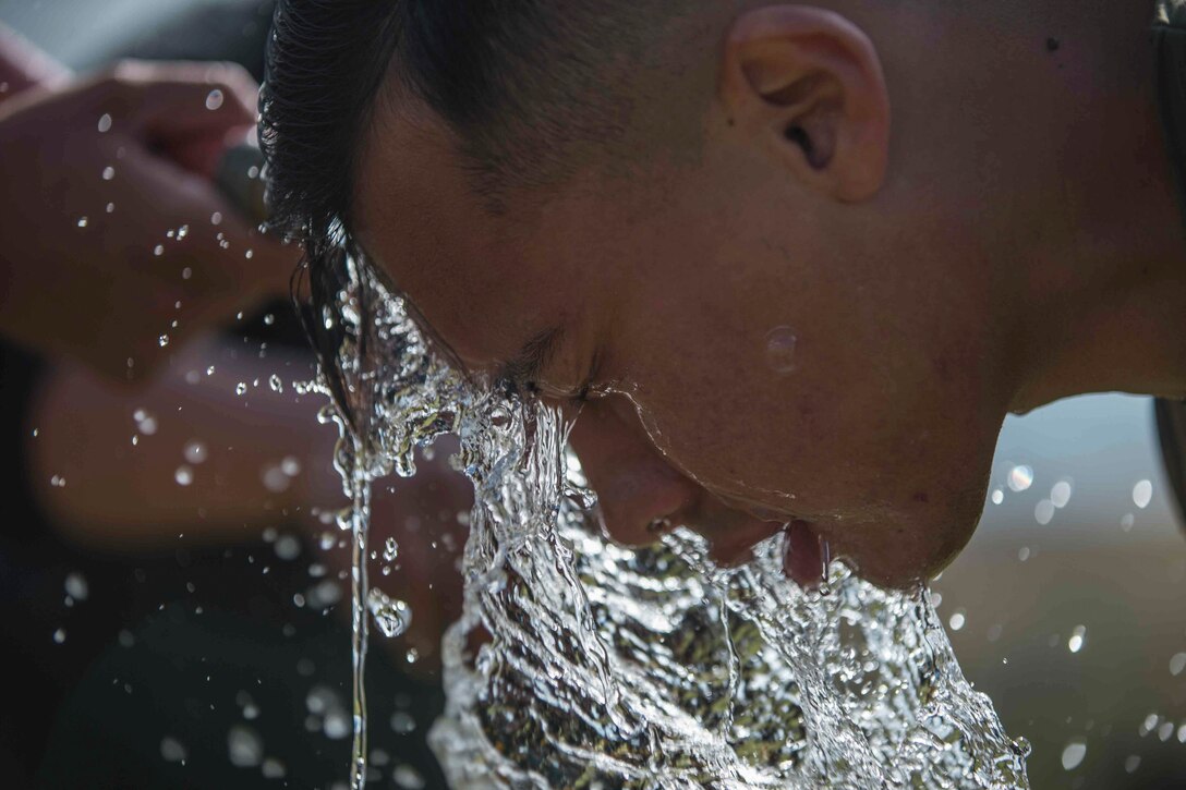 U.S. Marine Corps Cpl. Logan Ortega, a fire support Marine with India Battery, Battalion Landing Team 1/4, 15th Marine Expeditionary Unit, cleans oleoresin capsaicin off his face during a non-lethal weapons course at Marine Corps Base Camp Pendleton, California, May 19, 2020. Marines were sprayed with OC in preparation for possible riot control situations while being forward deployed. (U.S. Marine Corps photo by Cpl. Sarah Stegall)