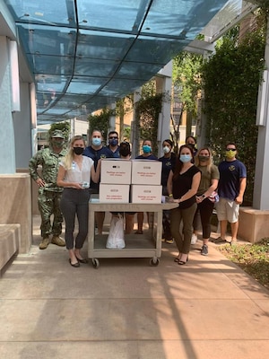 U.S. Central Command Navy senior enlisted leaders pose for a photo with lunches donated by the CENTCOM’s Chief Petty Officer Association to Tampa General Hospital employees on May 14, 2020.