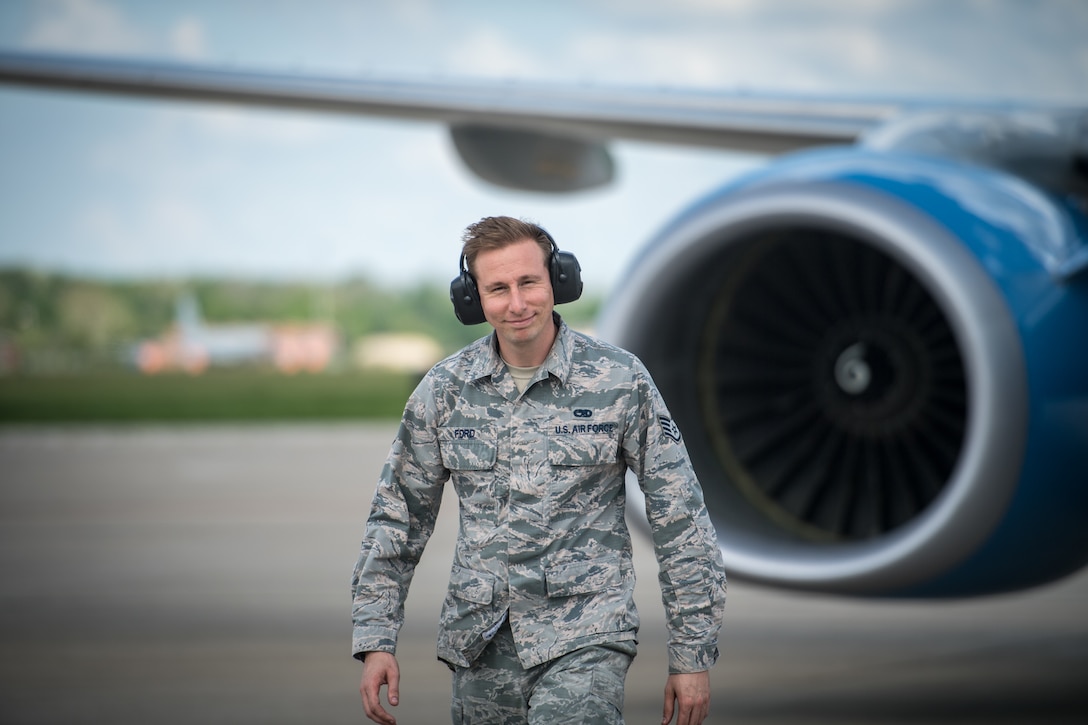 Staff Sgt. Damian Ford, 932nd Maintenance Squadron crew chief, is all smiles as he recovers a C-40, May 25, 2020, Scott Air Force Base, Illinois.  Crew chiefs have been working various shifts during COVID-19 to maintain the four C-40C aircrafts flown by the  932nd AW in support of essential training and operations. (U.S. Air Force photo by Christopher Parr)