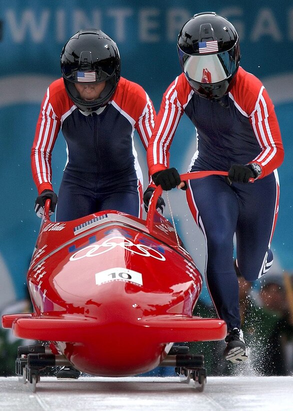 A bobsled team begins a race.