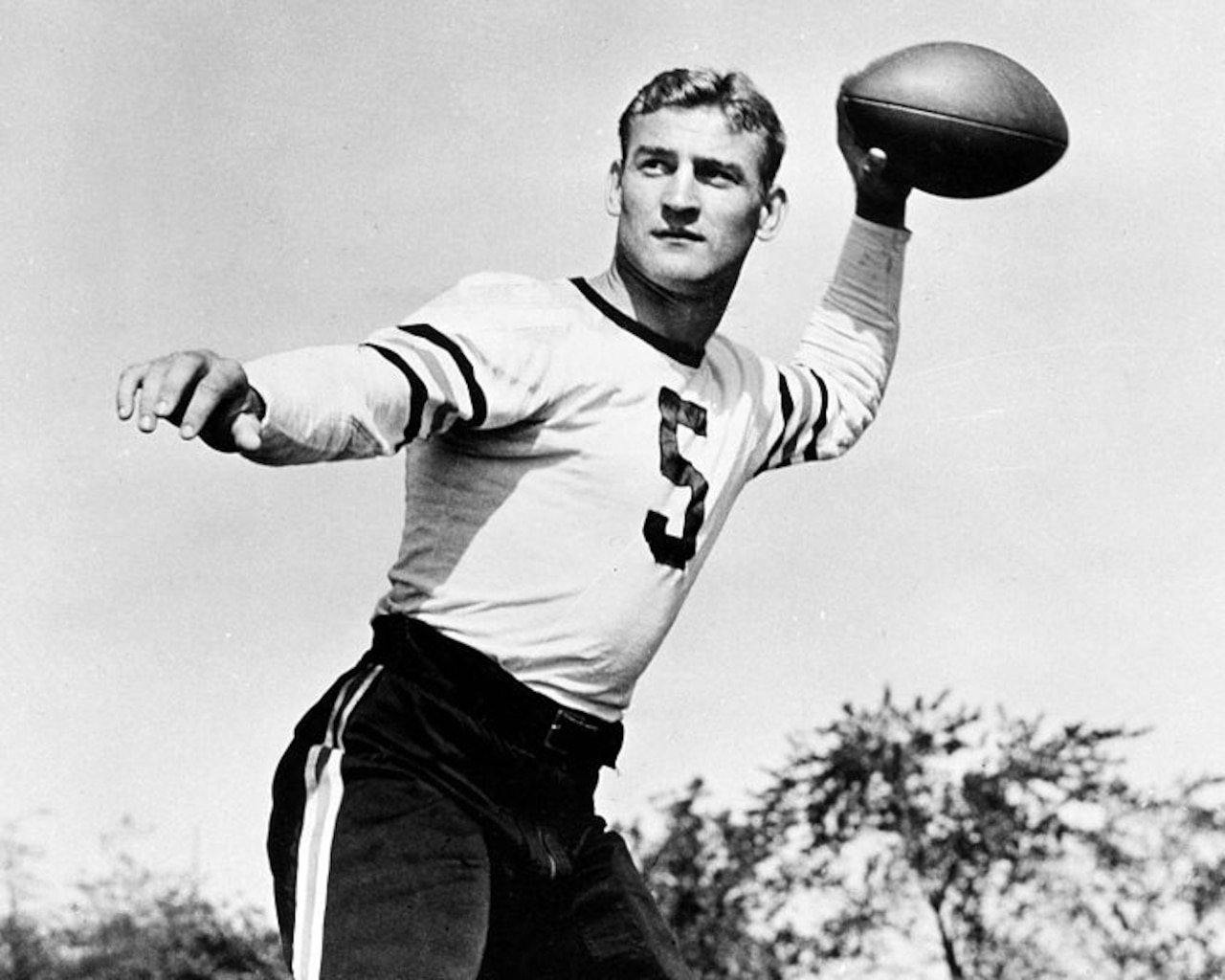 A football player poses for a photo.