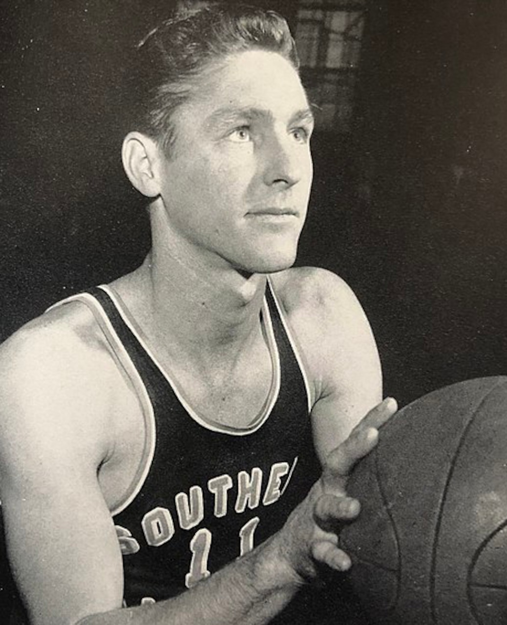 A basketball player poses for a photo.