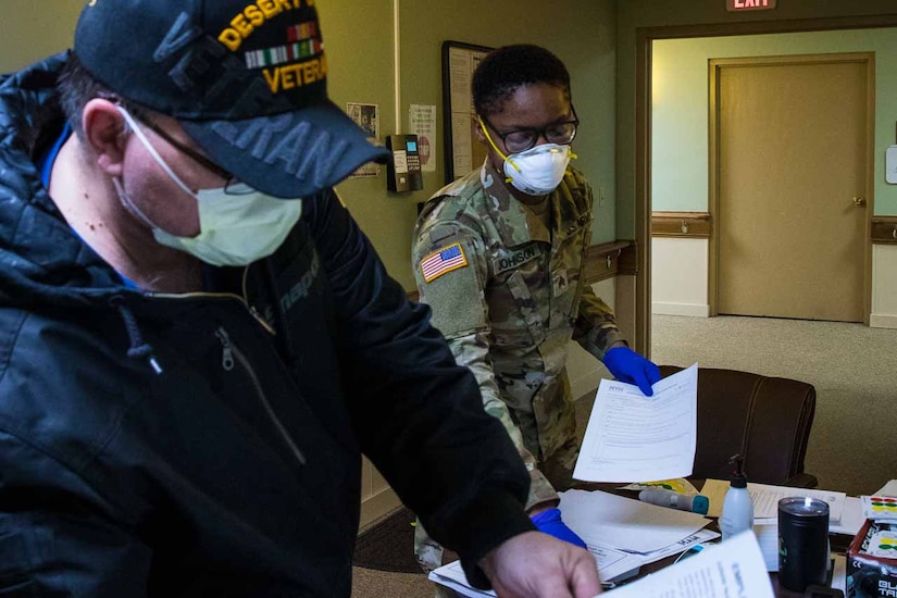 A health care worker picking up updated COVID-19 risk mitigation protocols.