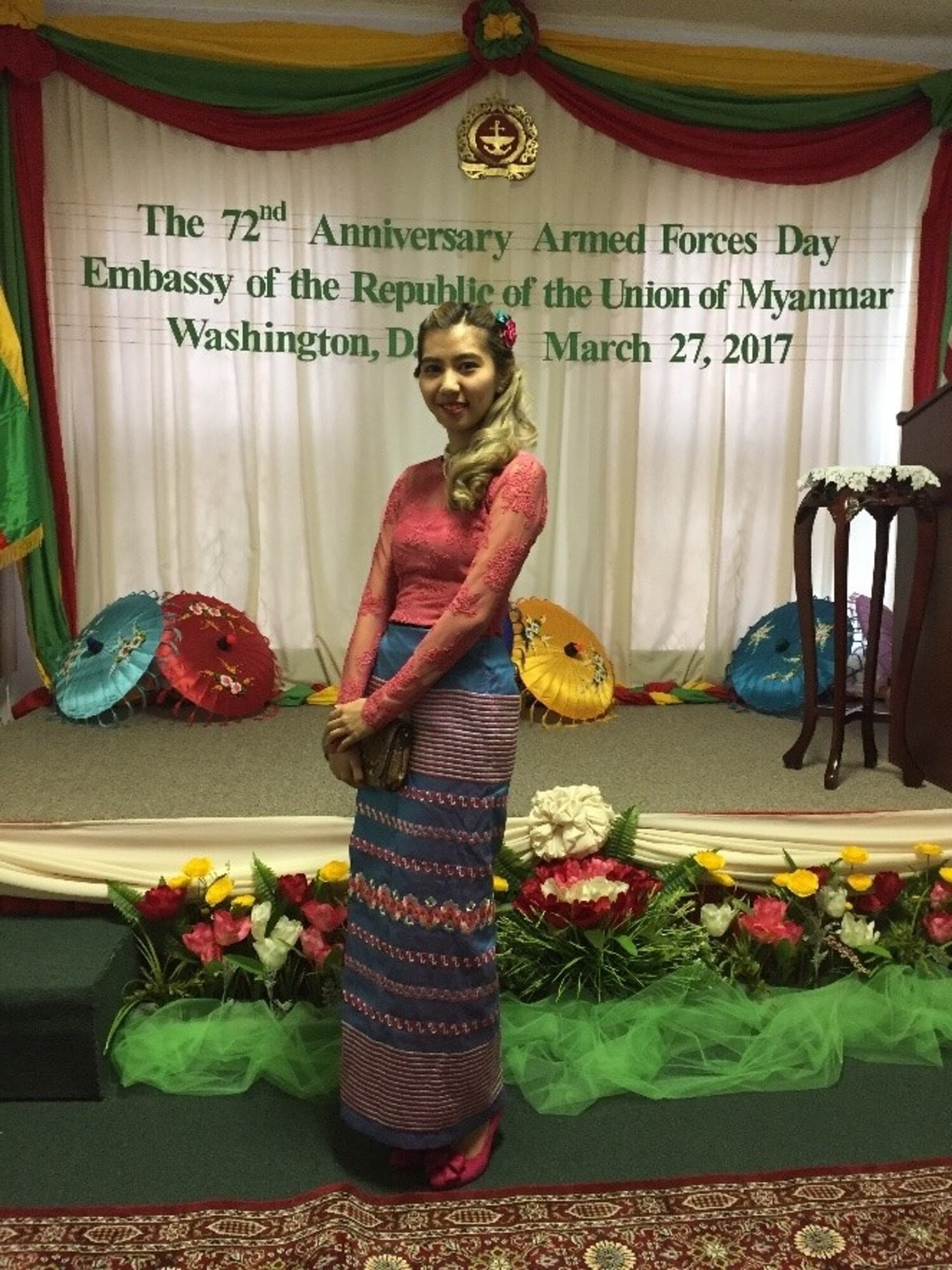 lady posing in front of banner in embassy of myanmar