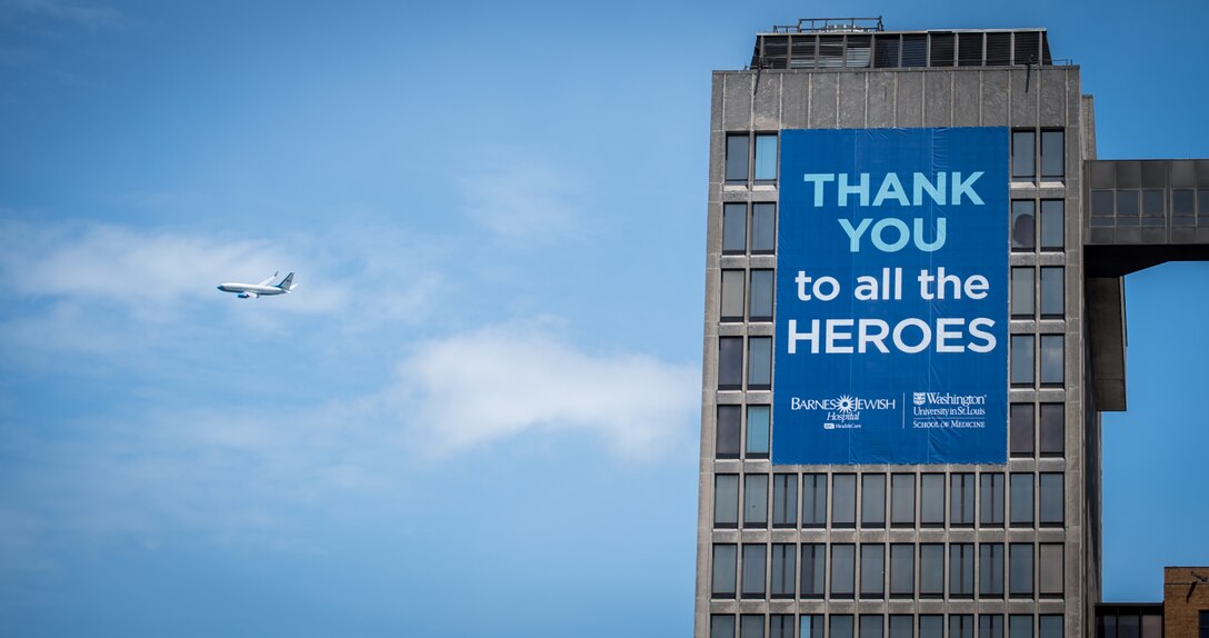 A single 932nd Airlift Wing C-40C passes by the Barnes-Jewish Hospital, May 25, 2020, St. Louis, Missouri, as part of the America Strong flyover campaign to honor all medical workers fighting COIVD-19.  (U.S. Air Force photo by Christopher Parr)