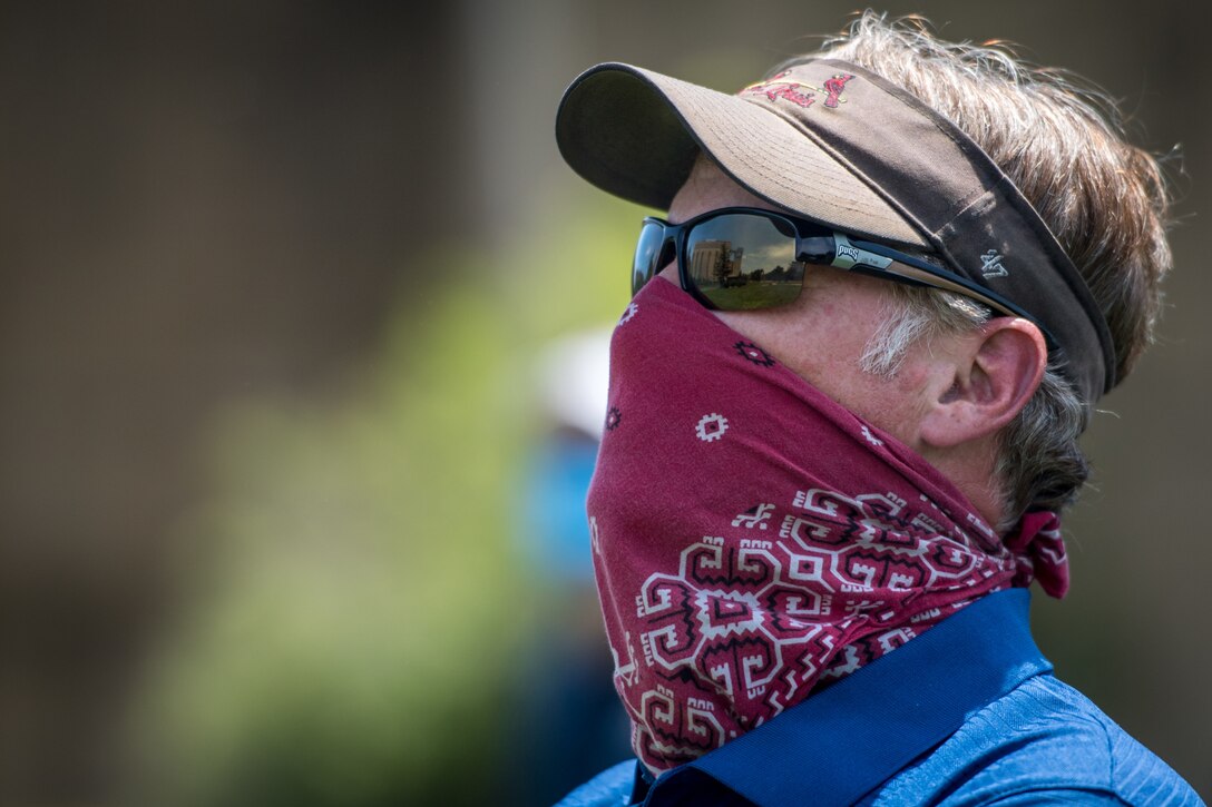 An onlooker watches as a 932nd Airlift Wing C-40C passes over Barnes-Jewish Hospital May 25, 2020, St. Louis Missouri, as part of the Department of Defense America Strong campaign to honor and salute those fighting the Coronavirus pandemic.  (U.S. Air Force photo by Christopher Parr)