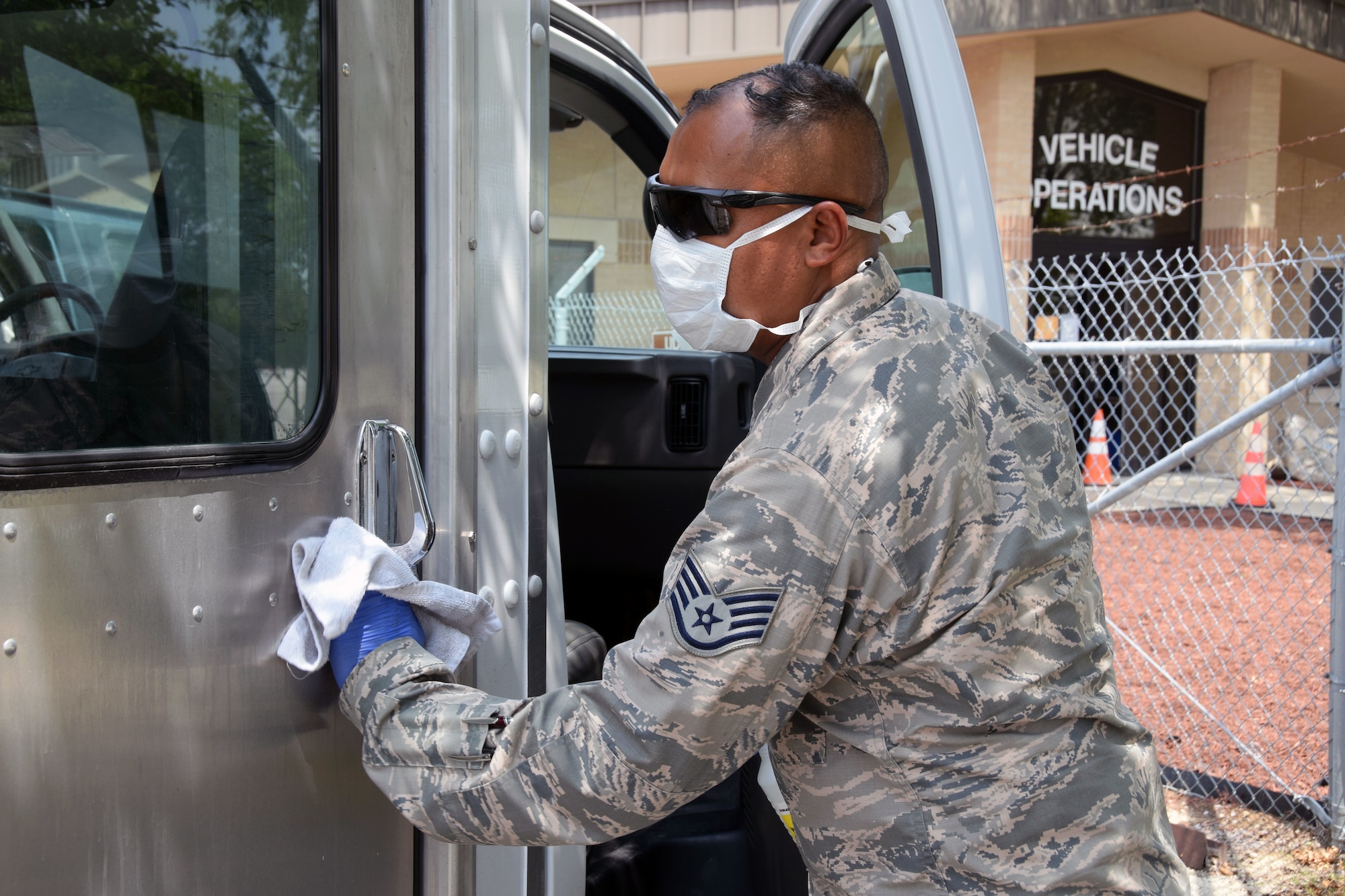 Staff Sgt. Aaron Antu, 433rd Logistics Readiness Squadron ground transportation operator, sanitizes a transportation vehicle being used to transport basic military training trainees who are being monitored for COVID-19 to and from medical facilities, May 21, 2020 at Joint Base San Antonio-Lackland, Texas.