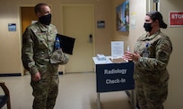 Col. Marc Greene, 628th Air Base Wing and joint base commander, listens to a brief at the immunizations clinic on Joint Base Charleston, S.C., May 21, 2020. Greene assumed command earlier this month, and he  toured the 628th ABW and multiple facilities to learn more about the Joint Base Charleston mission.