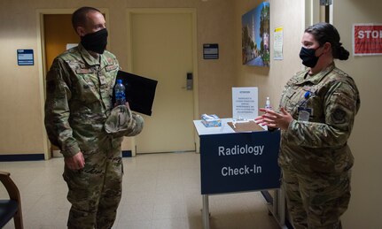 Col. Marc Greene, 628th Air Base Wing and joint base commander, listens to a brief at the immunizations clinic on Joint Base Charleston, S.C., May 21, 2020. Greene assumed command earlier this month, and he  toured the 628th ABW and multiple facilities to learn more about the Joint Base Charleston mission.