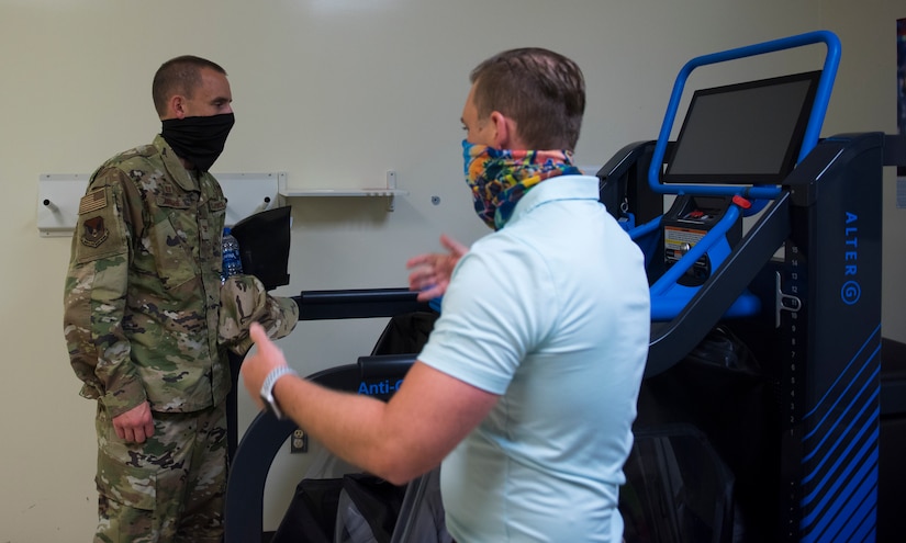 Col. Marc Greene, 628th Air Base Wing and joint base commander, is shown a machine used for physical therapy at the PT clinic on Joint Base Charleston, S.C., May 21, 2020. Greene assumed command earlier this month, and he  toured the 628th ABW and multiple facilities to learn more about the Joint Base Charleston mission.