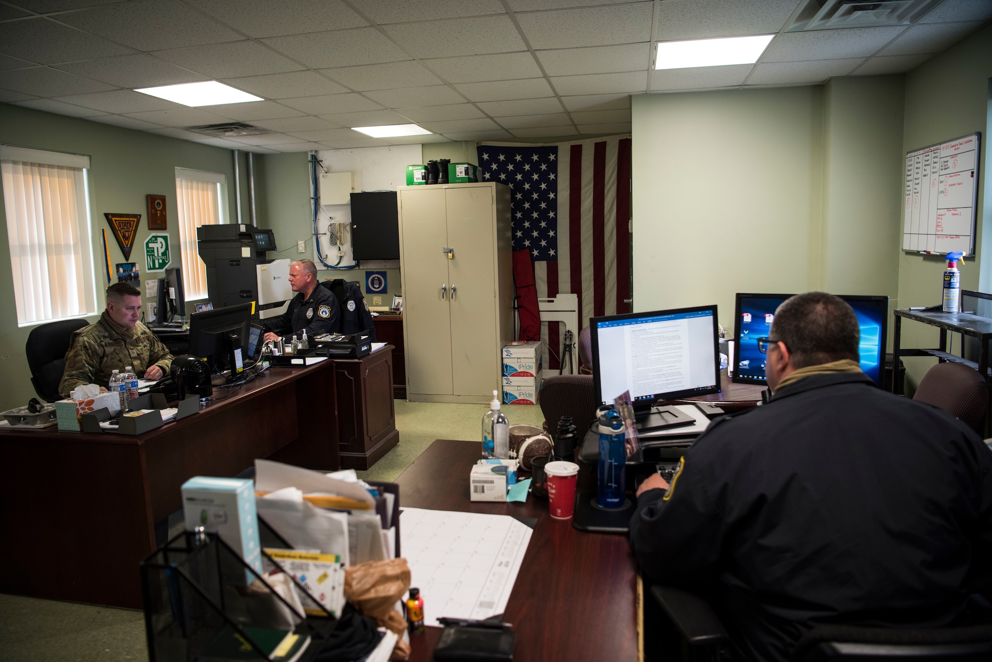 Photo of Security Forces members working at their desks.