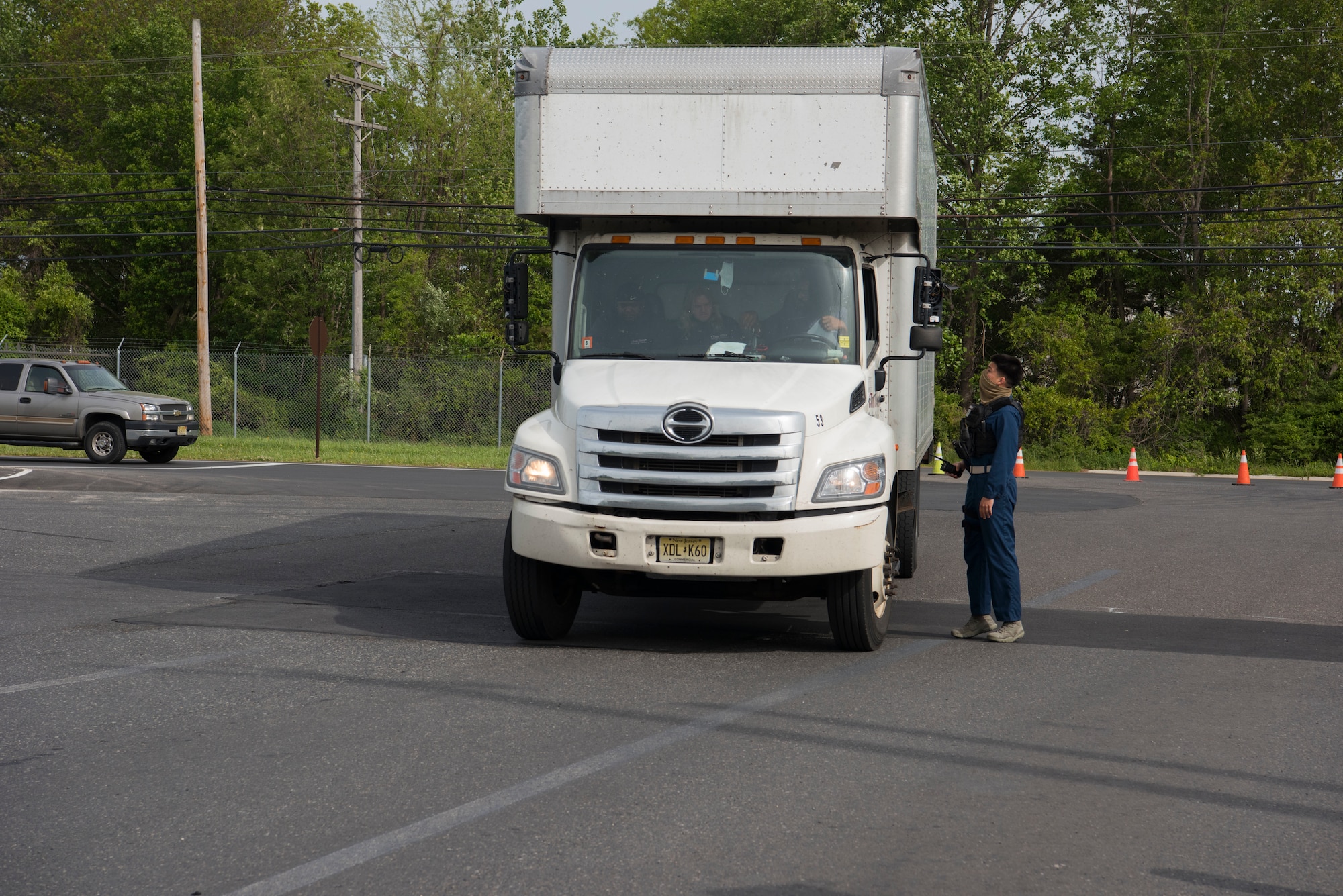 Photo of a security forces member directing a vehicle.