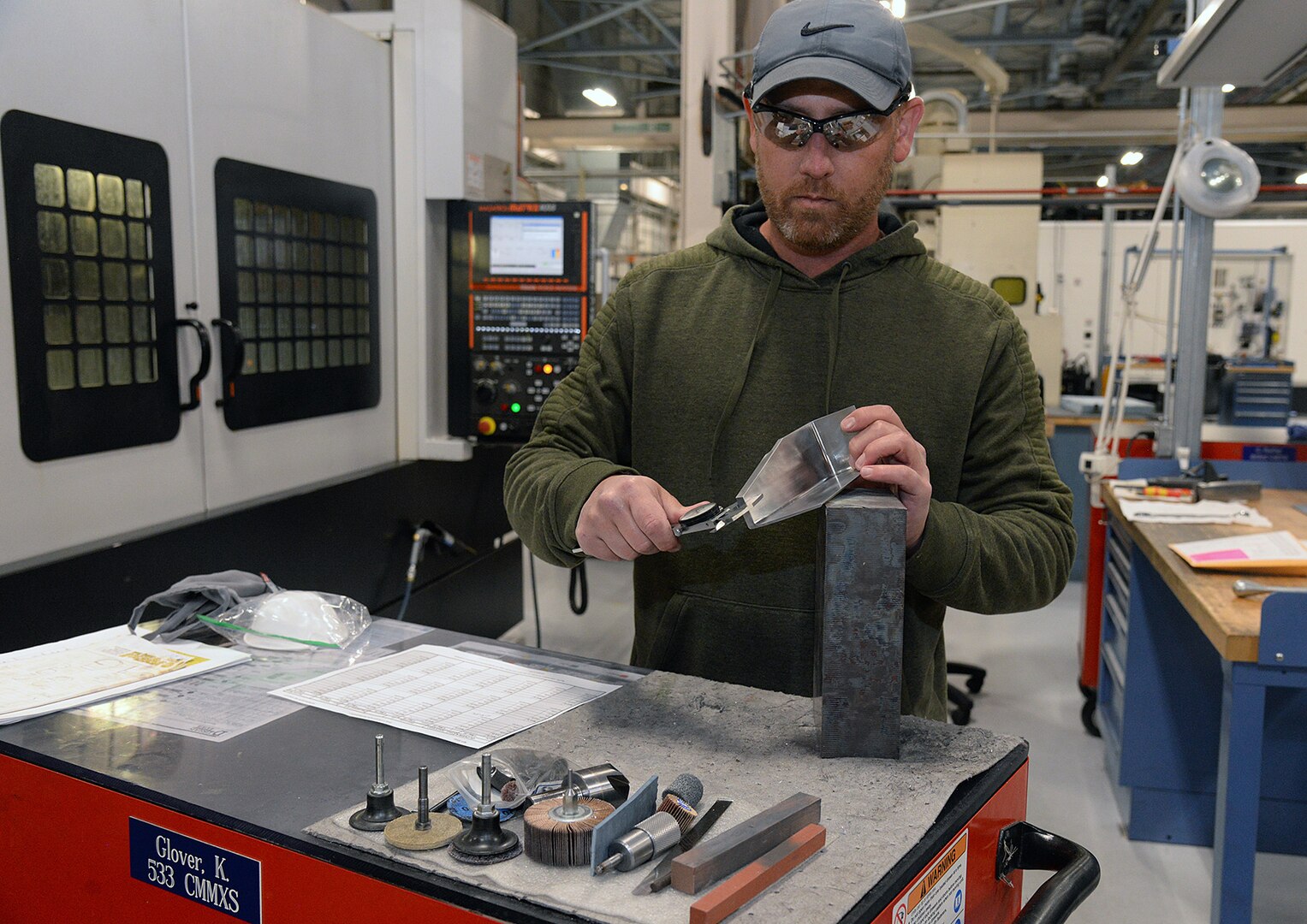Kerry Glover, performs an inspection on an F-16 bulkhead aircraft part May 5, 2020, at Hill Air Force Base, Utah. The skilled engineers and technicians of the 533rd CMMXS in the Ogden Air Logistics Complex, design, prototype and manufacture thousands of critical components annually, that can’t be found anywhere else in the world. The parts are manufactured in order to bridge a gap in the regular supply system, when there’s no contract in place from an outside source.