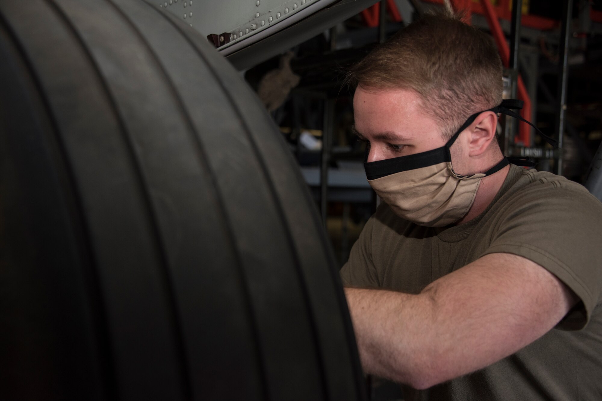 A photo of a maintainer installing a wheel