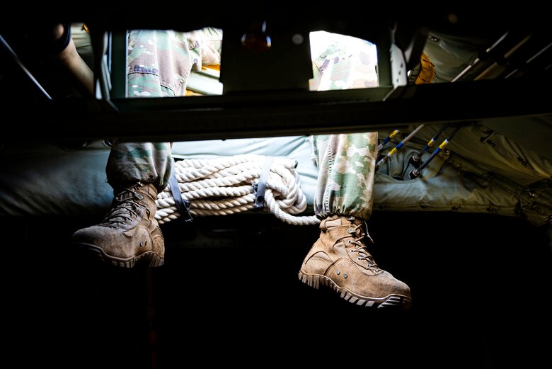 Photo of Airmen sitting atop an HC-130J Combat King II.