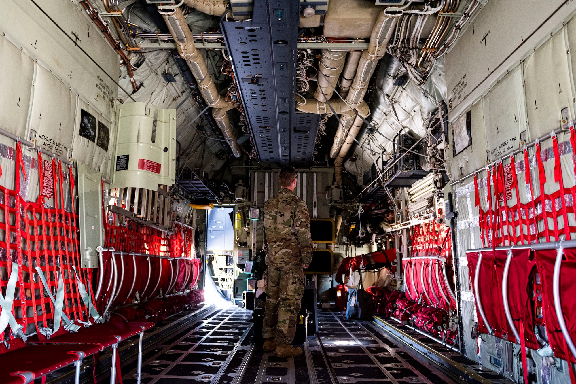 Photo of Airman examining an HC-130J Combat King II.